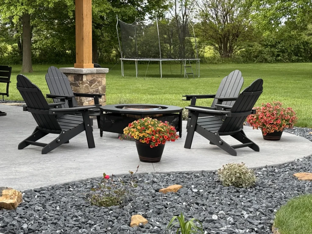 Fire pit installation in Fairfax with Adirondack chairs on a backyard patio