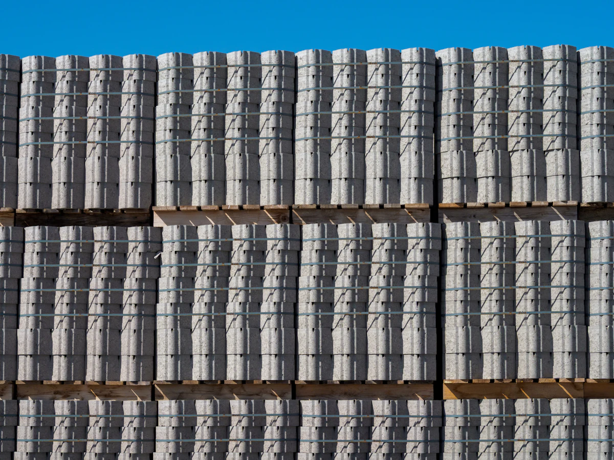 Pallets of new concrete pavers ready for a patio project