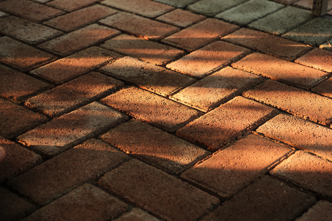 Red brick pavers laid in a herringbone pattern