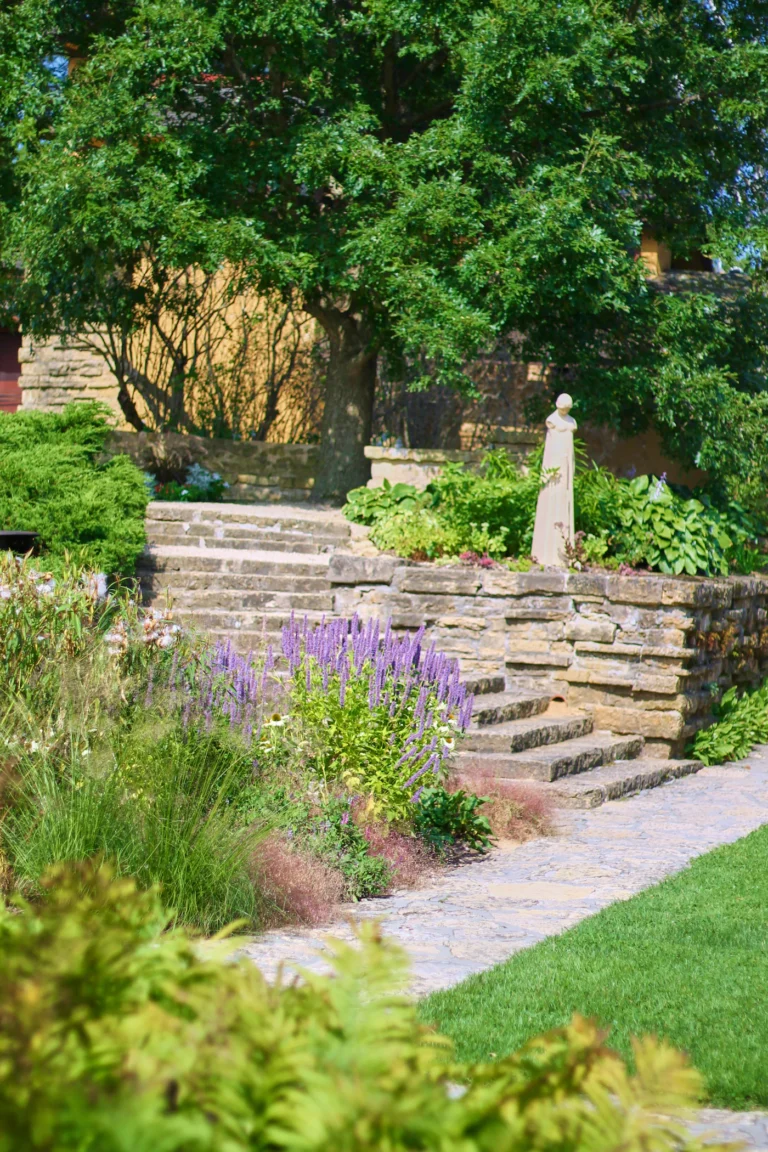 Natural stone garden steps with flowering plants