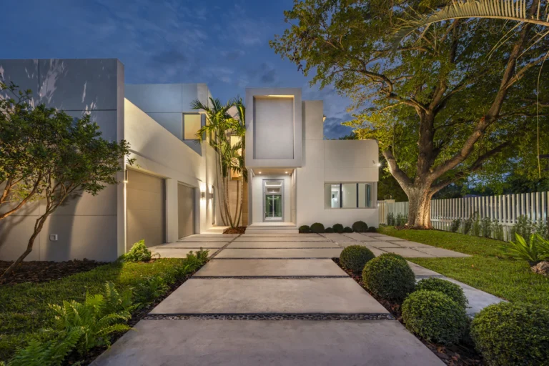 Paver walkway leading to a modern home entrance